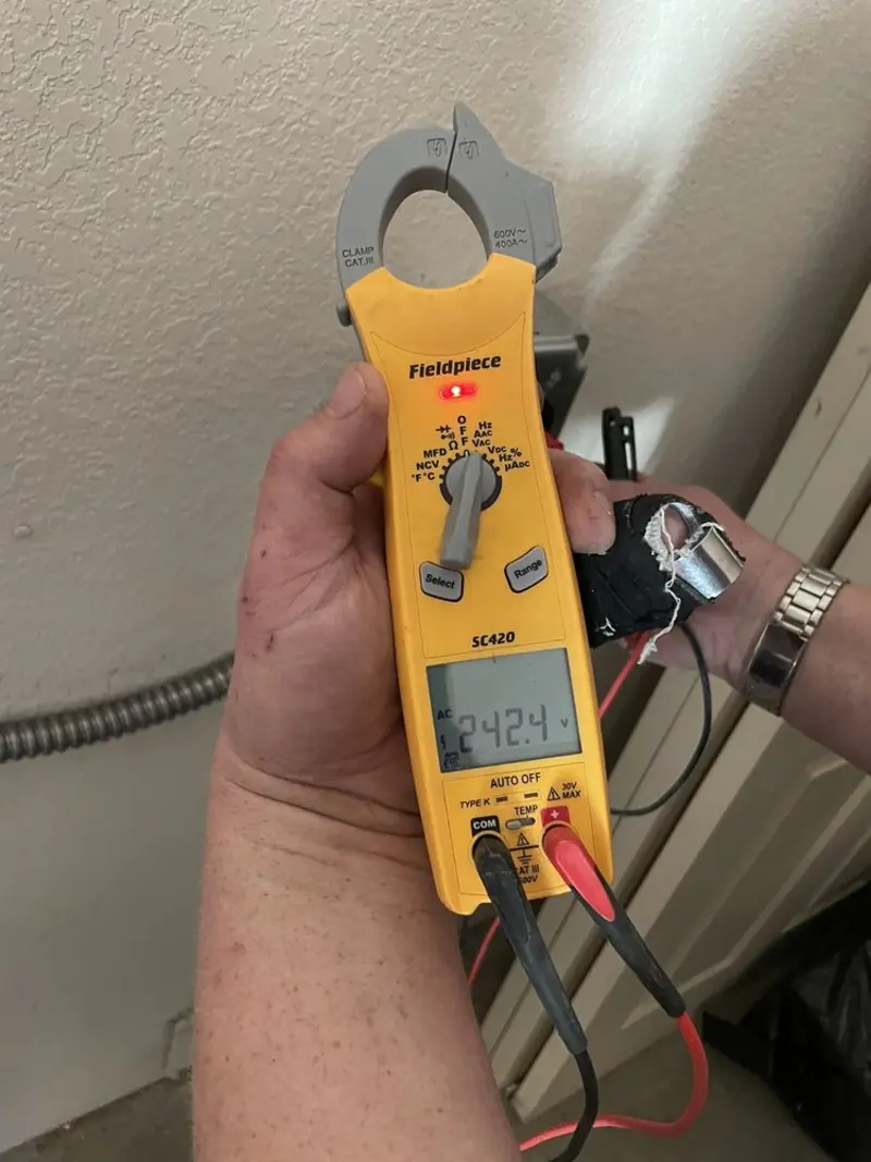 Voltage testing with clamp meter during Electrical Installation Services in North Wales